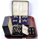 A pair of silver toast racks, Sheffield 1933, cased; a six piece condiment set, in a fitted case;