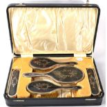 A silver and tortoiseshell five piece dressing table set, London 1919, in a fitted case