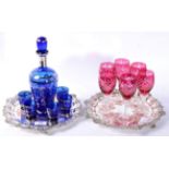Two plated trays and coloured glassware