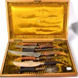 An oak cased seven piece antler handled and silver collared carving set