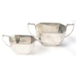 A silver cream jug and sugar bowl