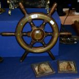 A ship's wheel; and a pair of tiles with marine decoration (3)