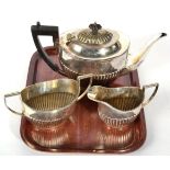 A Canadian metalware three piece tea service, stamped Birks Sterling, part fluted oval form, the