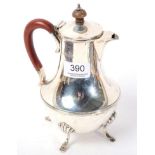 A silver hot water jug