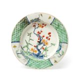 An Early Worcester Porcelain Plate, circa 1752, painted in famille verte style with a bird perched