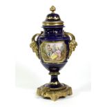 A Gilt Metal Mounted Sèvres Style Porcelain Urn Shaped Vase and Cover, with Bacchus mask handles,