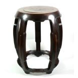 A Chinese Hardwood Barrel Stool, Qing Dynasty, on five curving supports with peripheral stretcher,