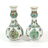 A Pair of Chinese Porcelain Bottle Vases, Kangxi, with garlic necks, painted in famille verte