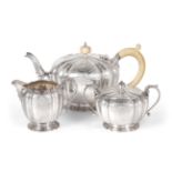 A Silver Three Piece Tea Service, Garrard & Co, Birmingham 1967, fluted circular form, with an