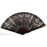 A Circa 1905 Tortoiseshell Fan, the monture piqué, the black gauze leaf decorated in swags with