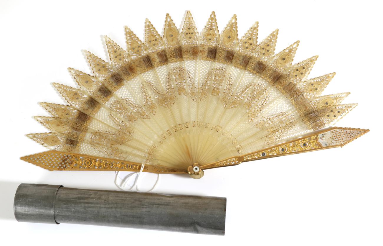 An Unusual Gothic Regency Brisé Fan, the inner sticks of pale horn, the guards of gold metal with