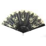 A Circa 1900-10 Fan, the leaf of black net embroidered with sprays of iris and leaves and