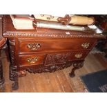 Reproduction carved mahogany lowboy on carved cabriole legs with ball & claw feet