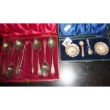 Silver cased set of engraved teaspoons with sugar tongs, and a pair of salts with spoons, both