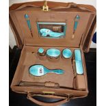 Leather vanity case with cloth cover containing blue guilloche silver vanity set of brushes,