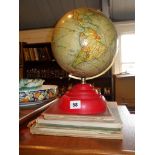 Vintage Geographica terrestrial globe with red bakelite base, and several old Atlases or Map Books