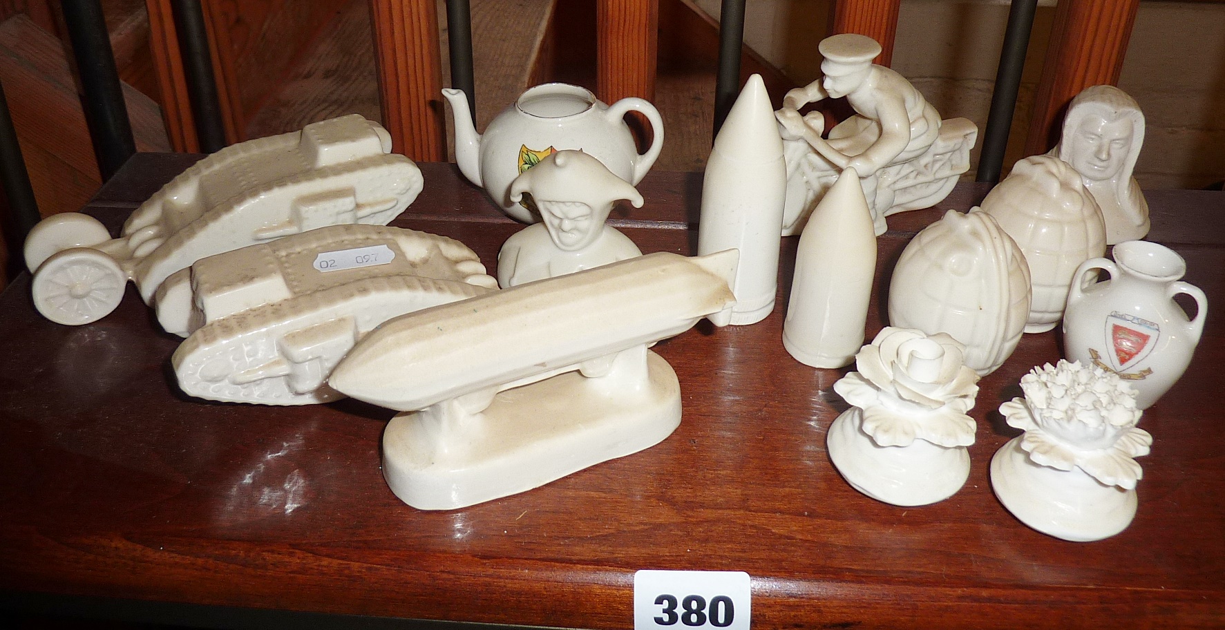 WW1 unusual blank crested china models of tanks, grenades, despatch courier, shells, a judge and a