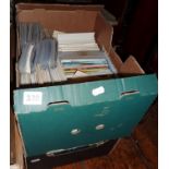 Two large boxes full of unsorted postcards