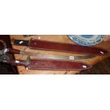 Two swords in leather scabbards and a Mexican sword