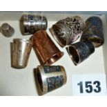 Eight thimbles, mostly silver, including filigree Swann thimbles and an Arts & Crafts hammered