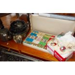 Vintage glass Christmas decorations, box of vintage Christmas crackers, and some silver plate