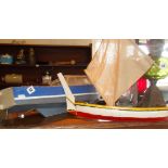 Wooden model of a cabin cruiser, and another of a Mediterranean sailing fishing boat