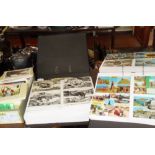 Two large albums of 'centre view' souvenir & seaside postcards and a collection of 1st Day Issue