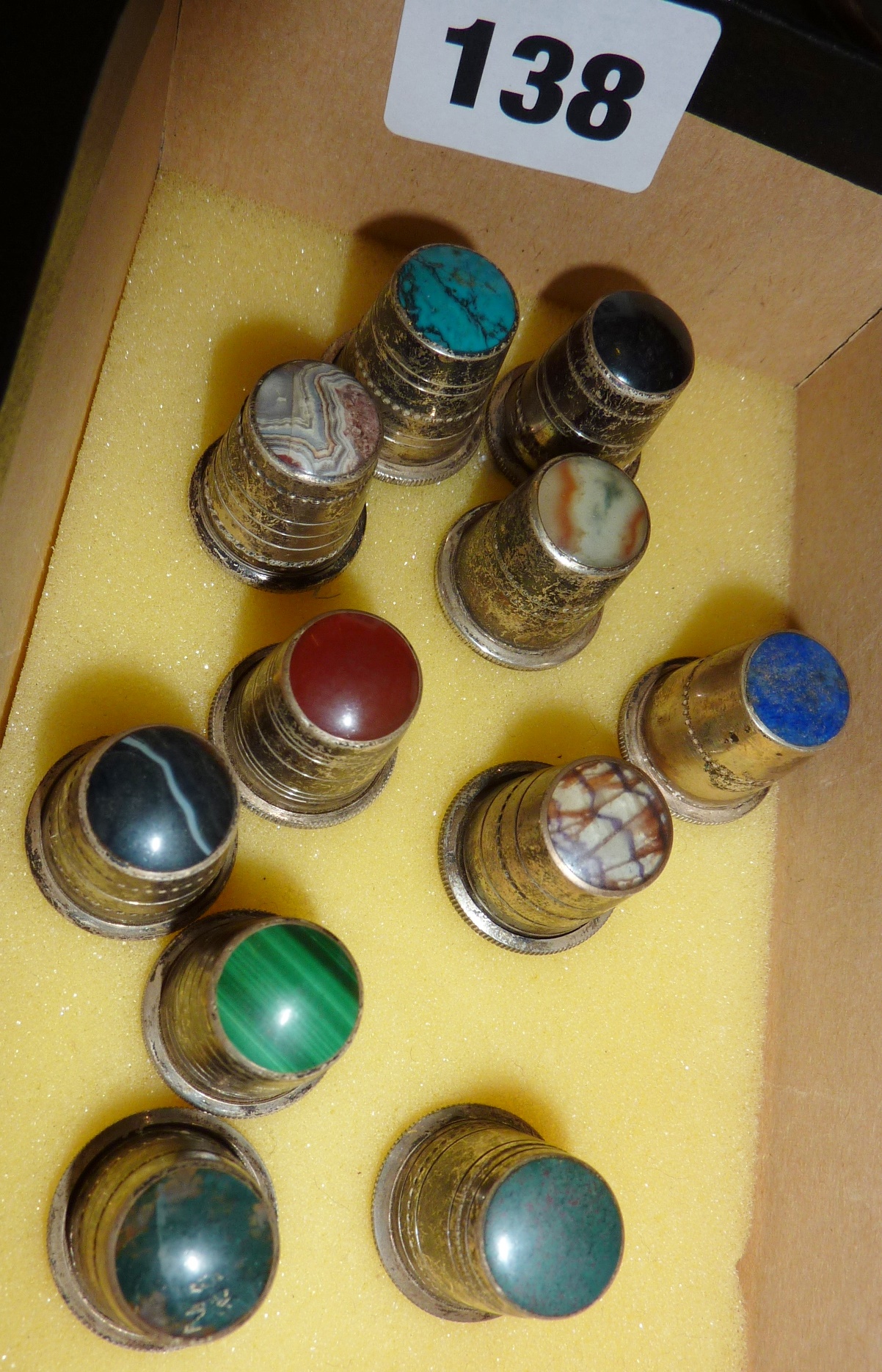 Eleven silver thimbles with semi-precious stone tops, by David Scott Walker