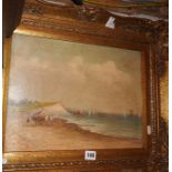 Marine oil on canvas of a coastal scene with seaweed gatherers on a beach, gilt frame, signed