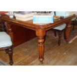 19th c. mahogany wind-out dining table of turned and fluted legs with extra leaf and winder, 178cm x