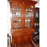 Victorian mahogany bookcase with two glazed doors above a deeper base with two doors