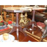 Pair of craftsman made mahogany wine tables having chip carved edges, centre column and four splayed