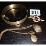 Two 9ct gold lockets, one with a ruby, a 9ct gold brooch inset with a ruby, and a 9ct rolled gold