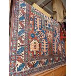 Antique Caucasian rug, a small Turkey rug and a machine-made rug