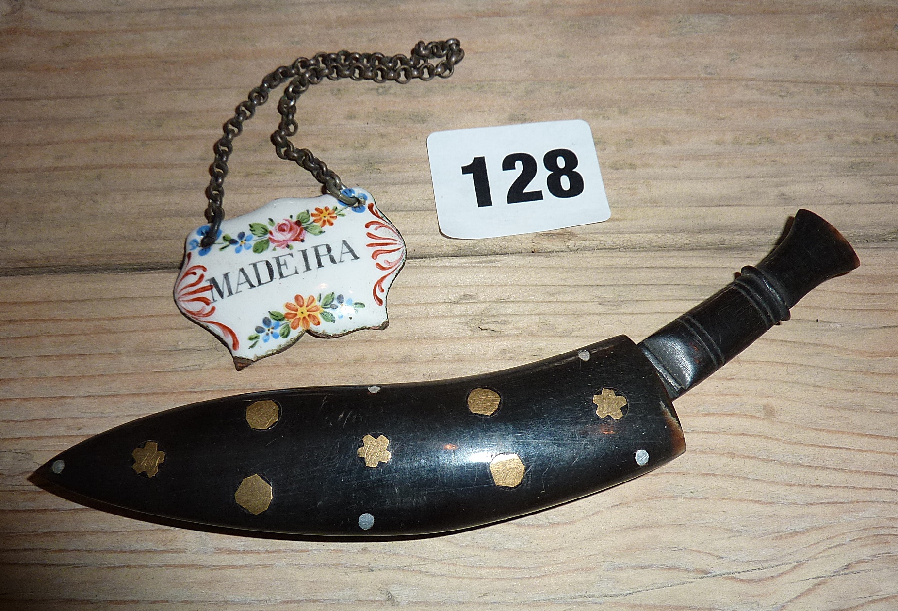 Carved horn Kukri dagger with inlaid horn sheath, and painted enamel decanter label "Madeira"