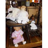 Four vintage dolls with composition heads (2 black and 2 white) and a dolls swing chair