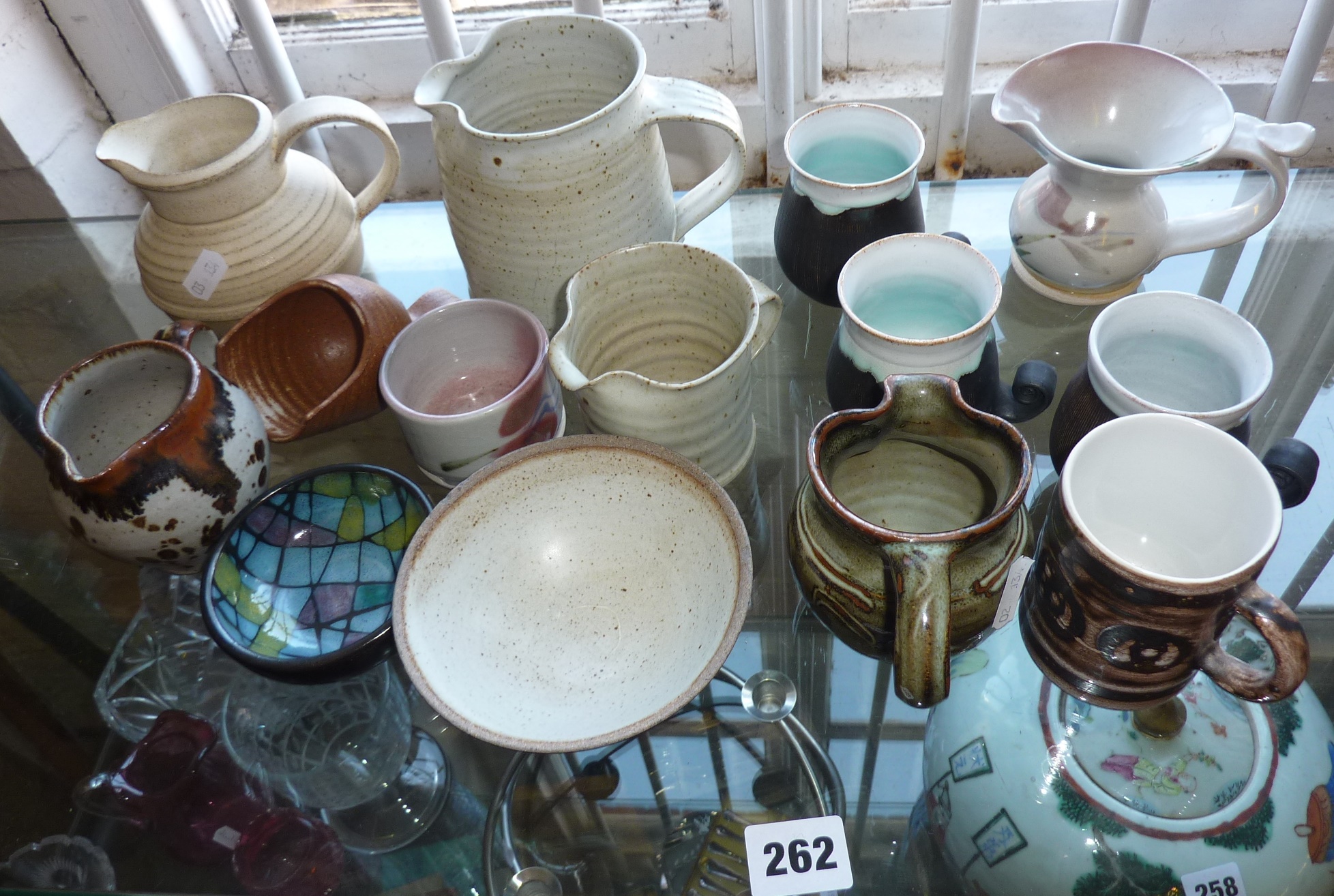 Quantity of studio pottery jugs and cups, inc. Lowerdown and Rye