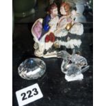 Continental porcelain group and two Swarovski items (inc. squirrel)