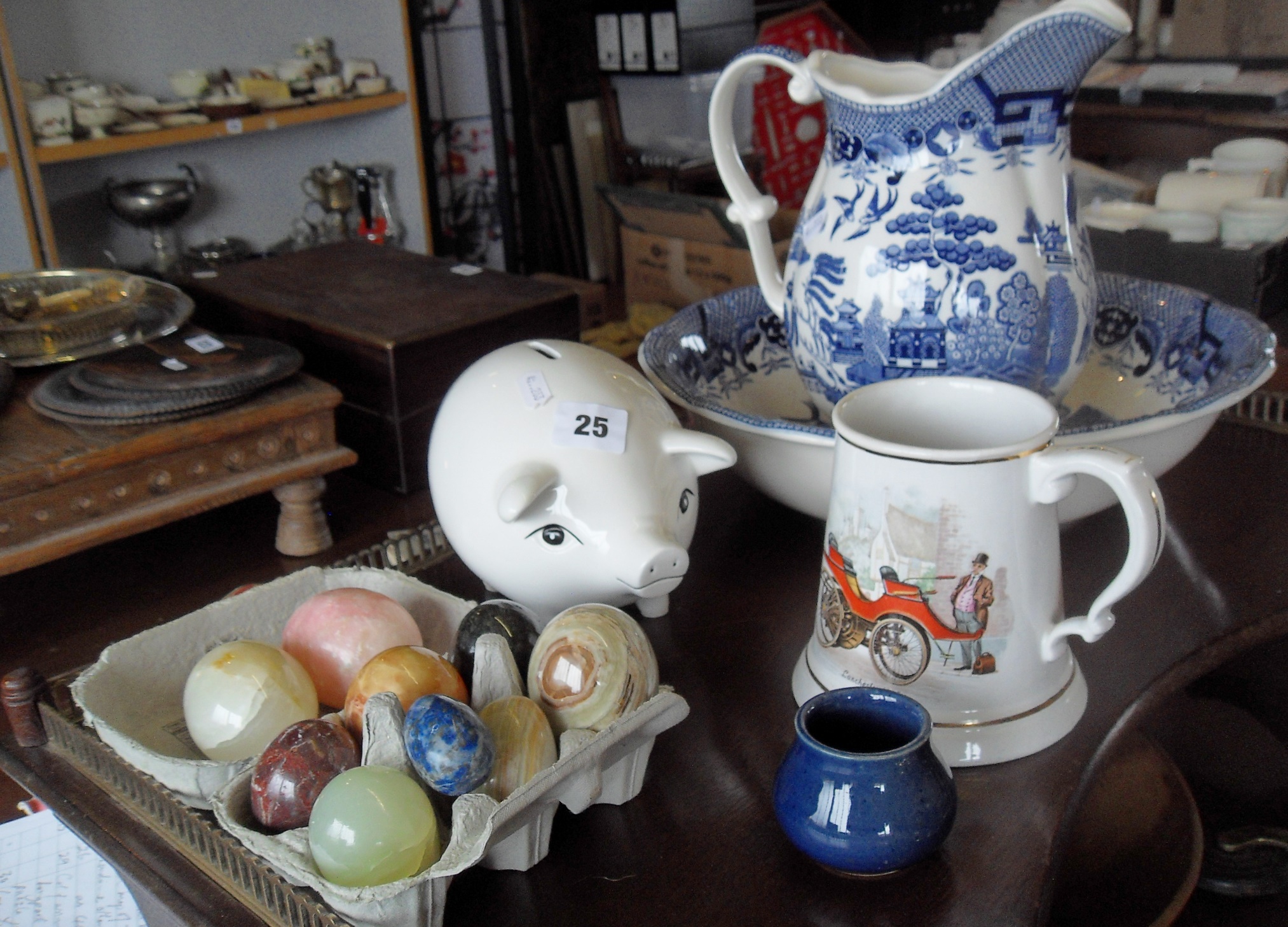 Nine various marble eggs, a china pig money bank, and a blue & white jug & basin set