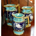 Set of three English graduated Majolica jugs decorated with storks on a turquoise ground, 19th c. (