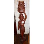 Carved wooden figure of lady carrying fruit