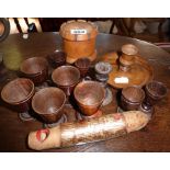 Treen 19th c. turned wood egg cups, two candlesticks, four tots, yew wood box and a 'bird' whistle