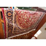 A modern Keshan rug on red ground, 1.90m x 1.40m