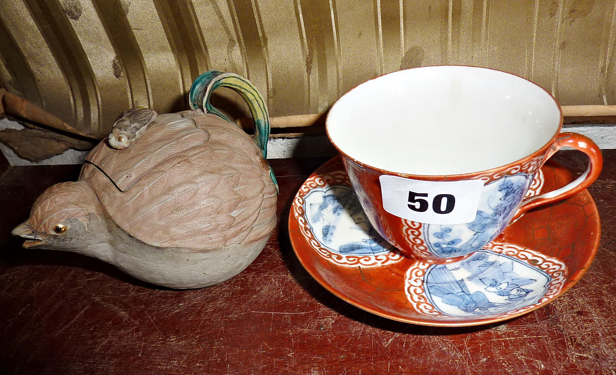 Japanese naturalistic porcelain teapot in the form of a quail, and a Kutani style cup and saucer,