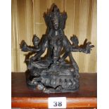 Indian bronze Shiva with three faces and multiple arms, approx 18cm high