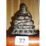 An early Chinese bronze buddha seated on a lotus flower base, approx 10cm high