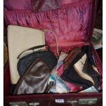 Vintage suitcase full of handbags and silk scarves