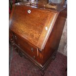 Ladies oak bureau on barleytwist legs with shaped stretcher