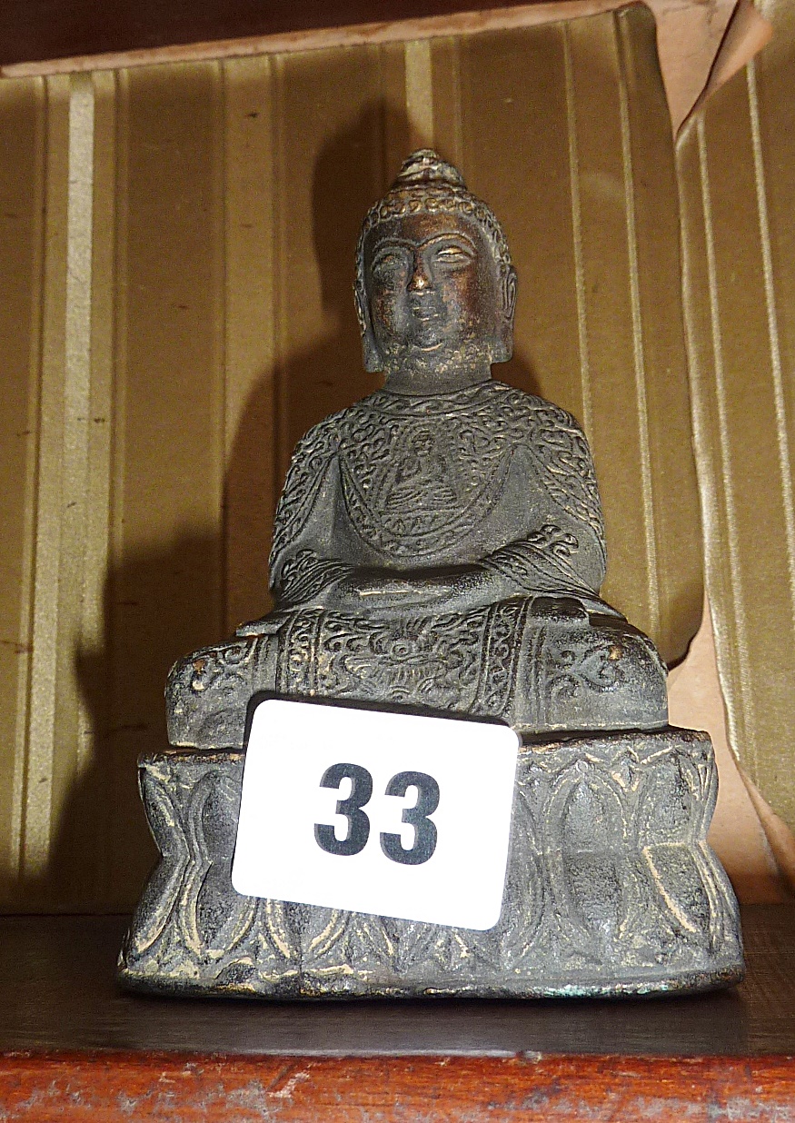 A Tibetan bronze figure of a seated Shakyamuni buddha - stamp on base, approx 13cm high