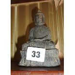 A Tibetan bronze figure of a seated Shakyamuni buddha - stamp on base, approx 13cm high